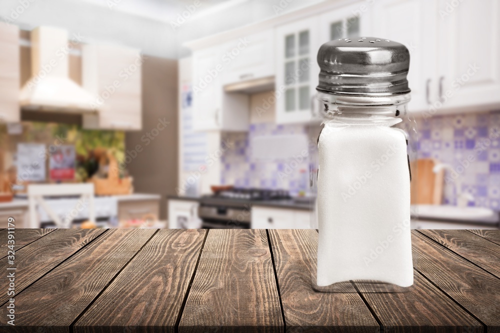 The salt glass bottle on wooden desk