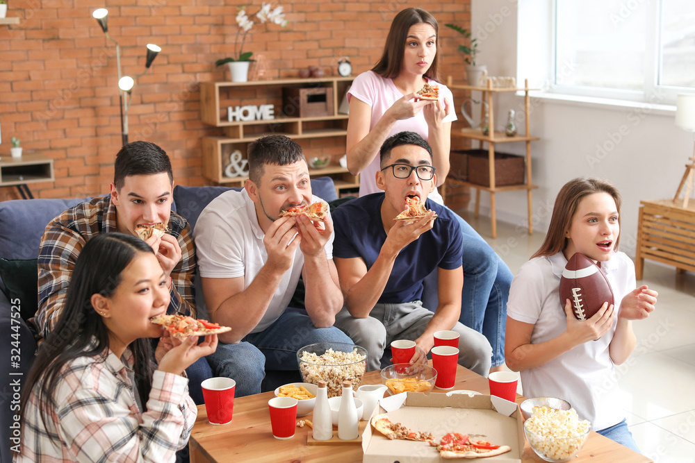 Group of fans watching rugby on TV