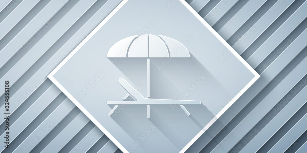 Paper cut Sunbed icon isolated on grey background. Beach umbrella and Sun lounger. Paper art style. 