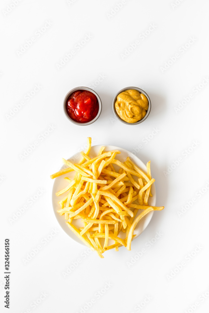 Fast food symbol. French fries on plate on white table top-down copy space