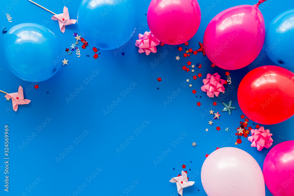 Party concept. Colorful balloons and confetti on blue background top-down frame copy space