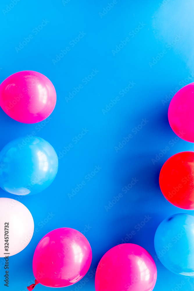 Decorative frame with colorful balloons on blue background top-down frame copy space