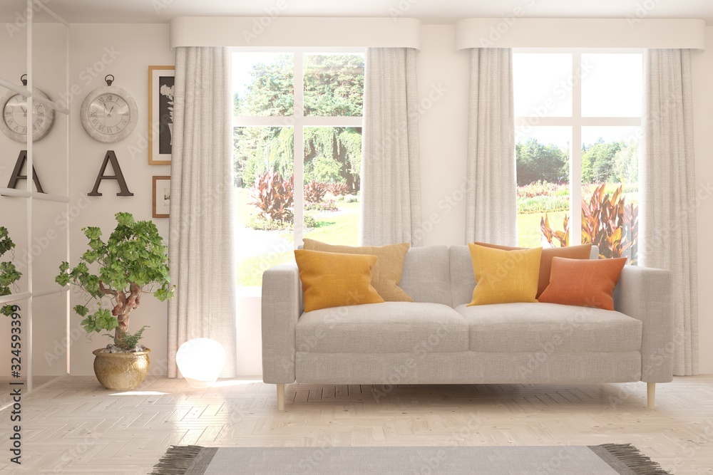 Minimalist living room in white color with sofa and summer landscape in window. Scandinavian interio