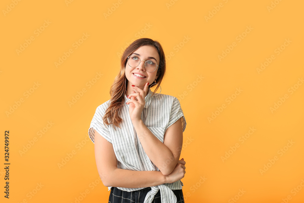 Thoughtful woman with stylish eyeglasses on color background