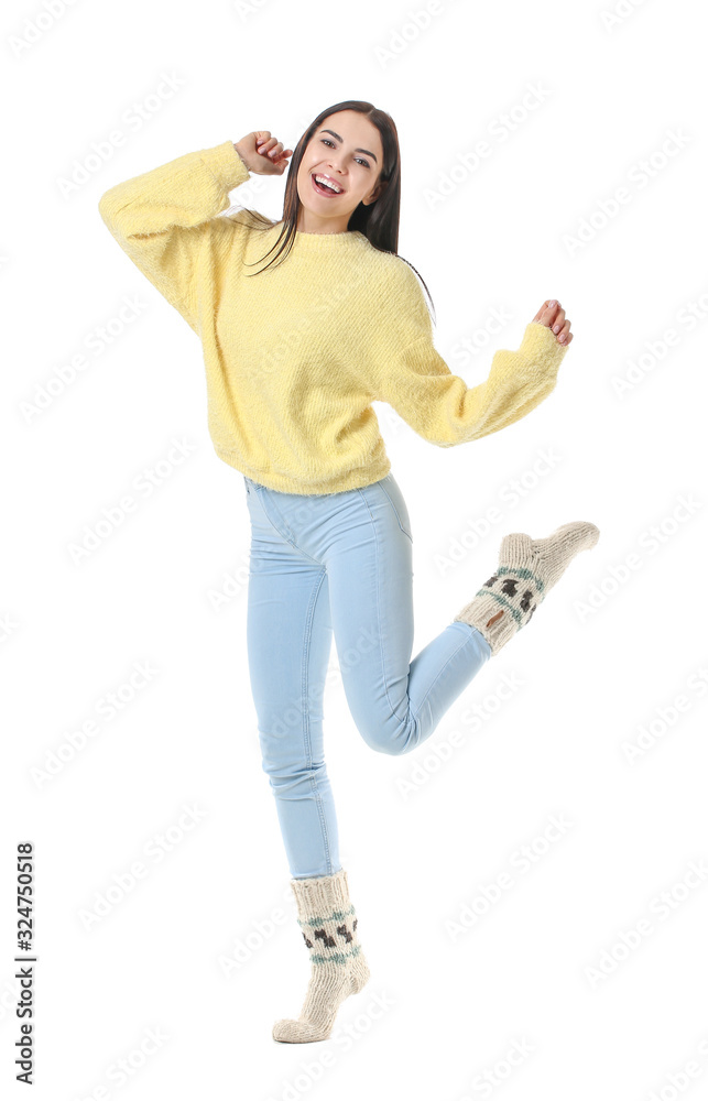 Beautiful young woman in warm sweater on white background