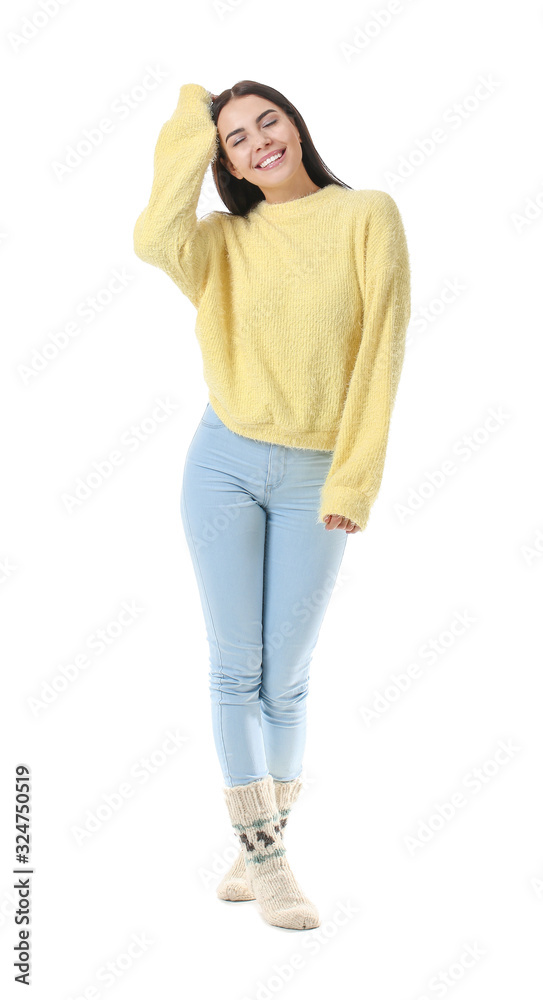 Beautiful young woman in warm sweater on white background