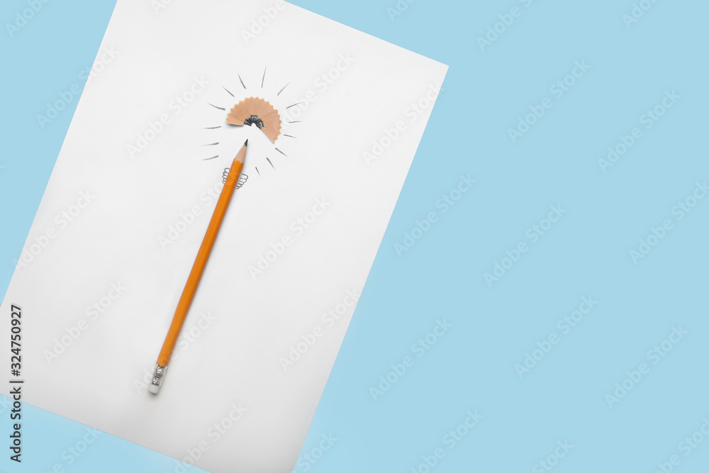 Ordinary pencil and paper sheet with drawing of light bulb on color background. Concept of idea