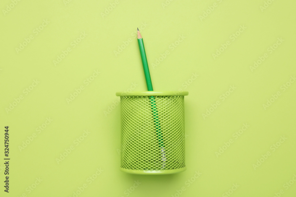 Holder with ordinary pencil on color background