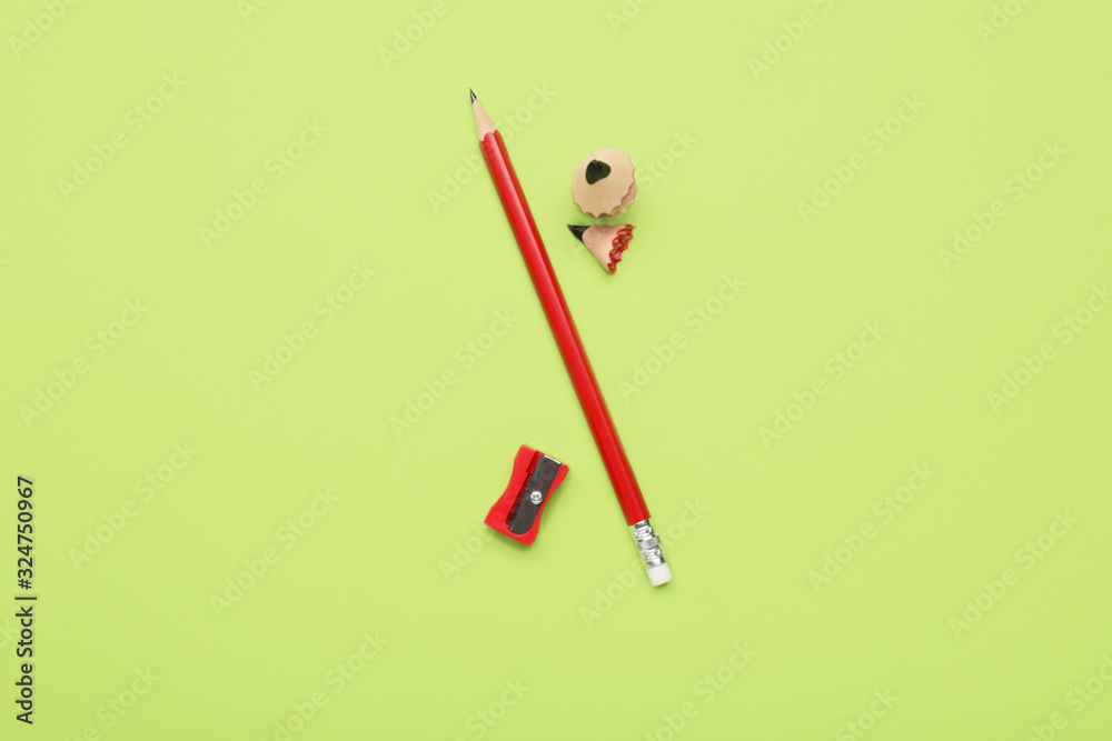 Ordinary pencil and sharpener on color background