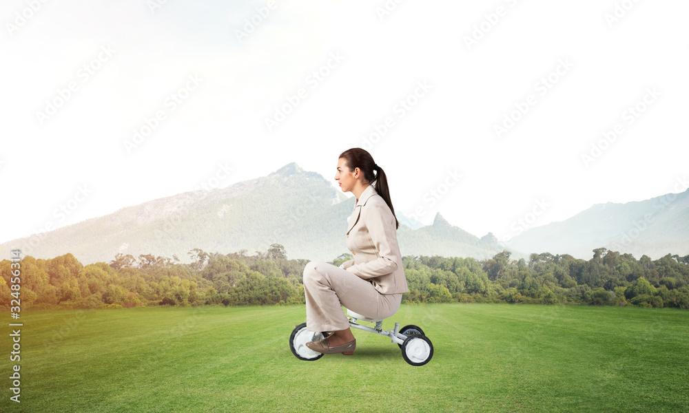 Beautiful young woman riding childrens bicycle