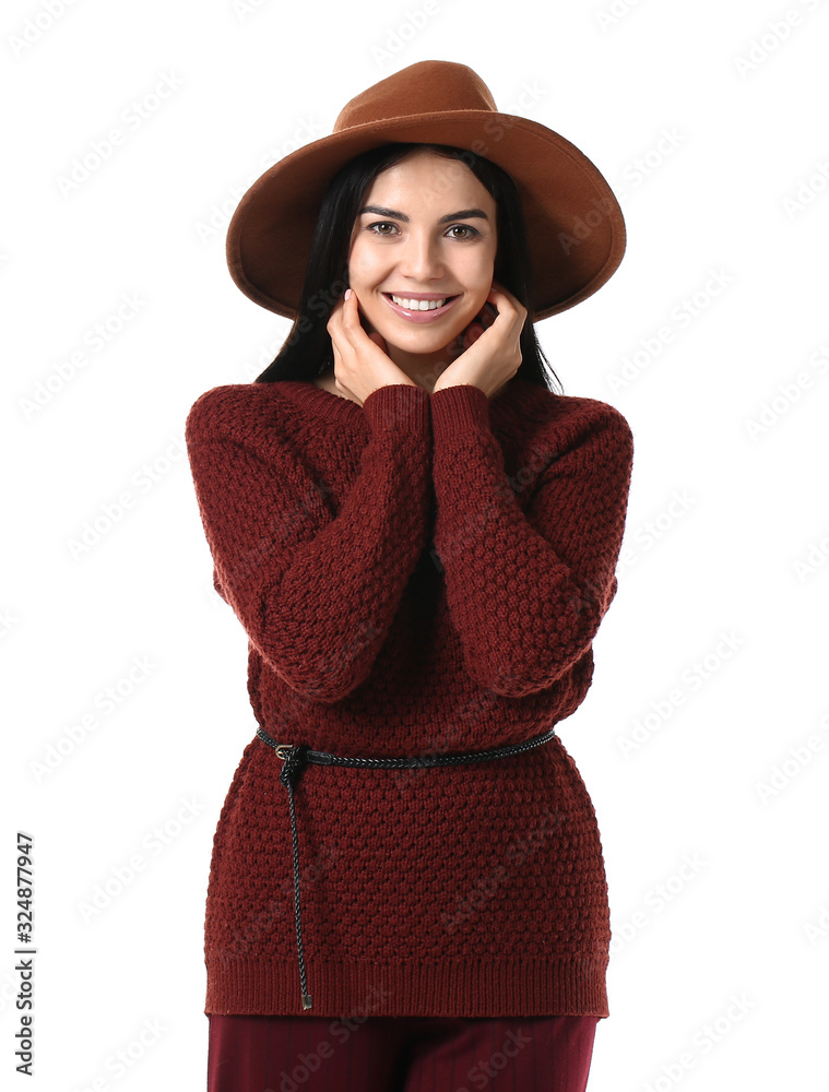 Beautiful young woman in warm sweater on white background