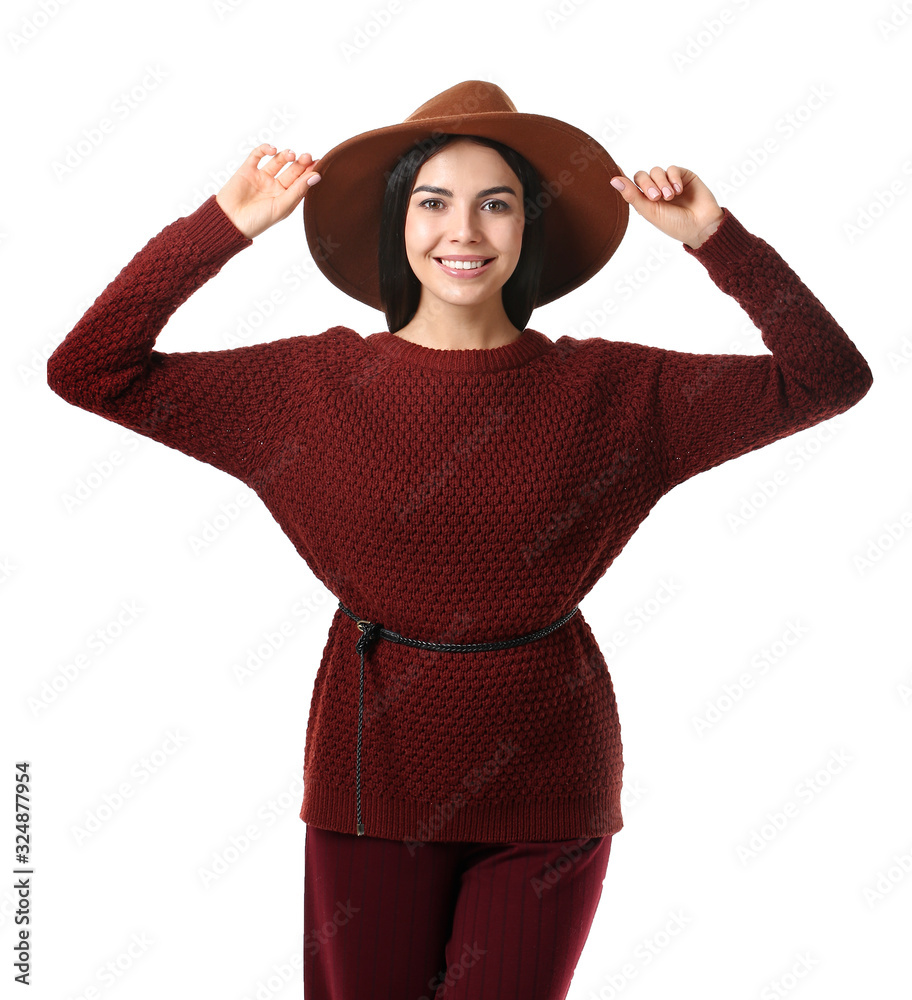 Beautiful young woman in warm sweater on white background