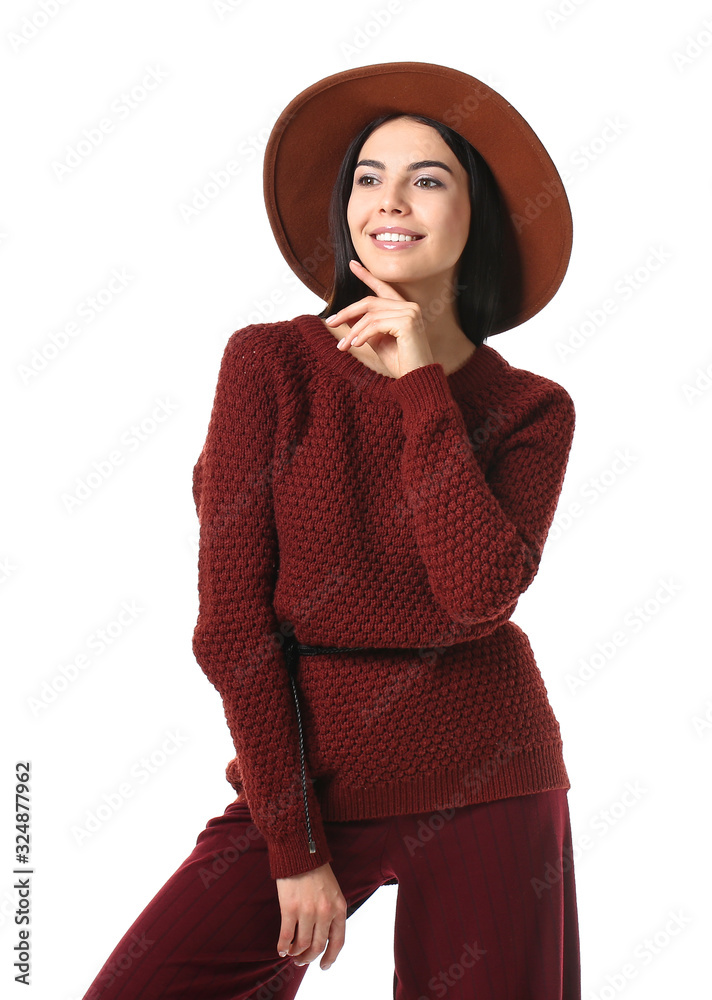 Beautiful young woman in warm sweater on white background