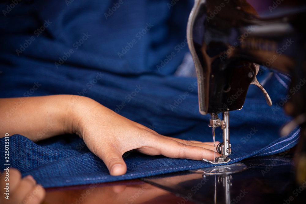 Close-up of womens hand sewing fabric,Sewing with traditional uniforms