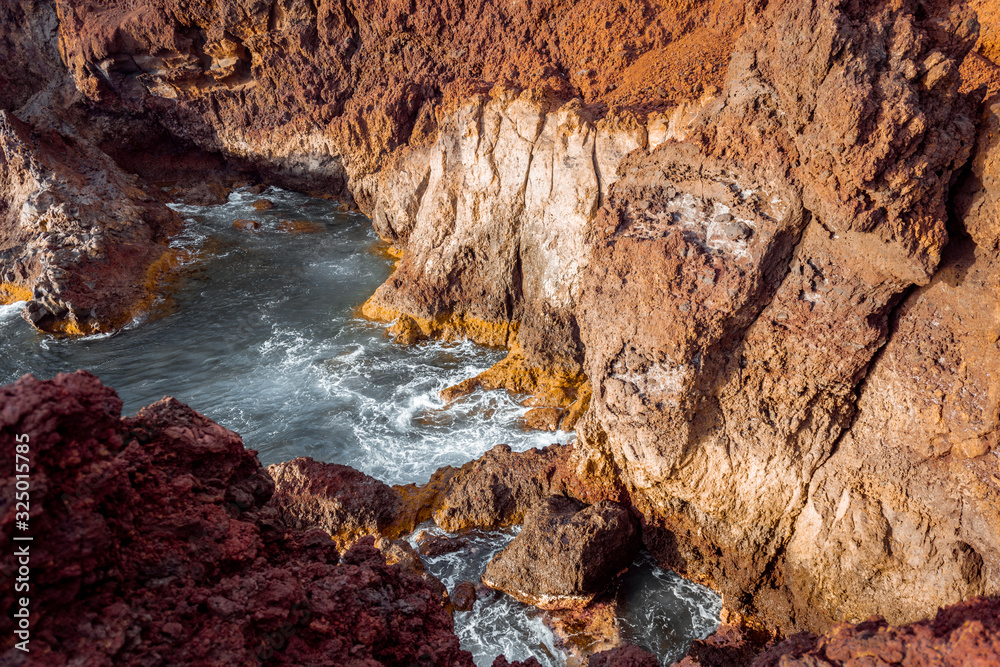 Beautiful landscape on a rocky coast with wavy ocean during a sunset. Teno cape on the north-west of