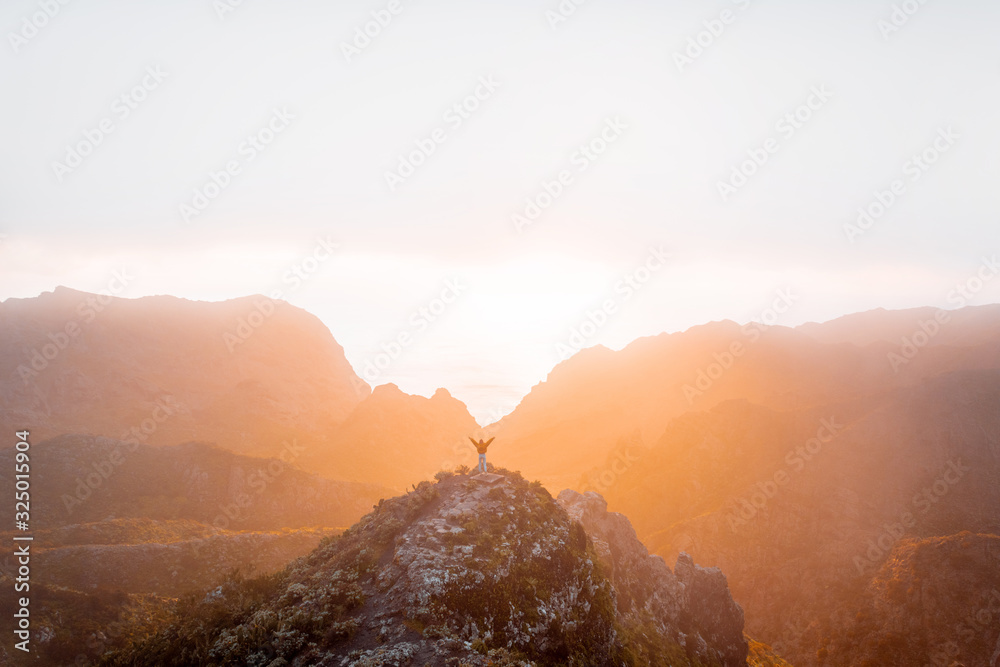 Breathtaking scenery on the mountain range under the clouds and ocean on the background during a sun