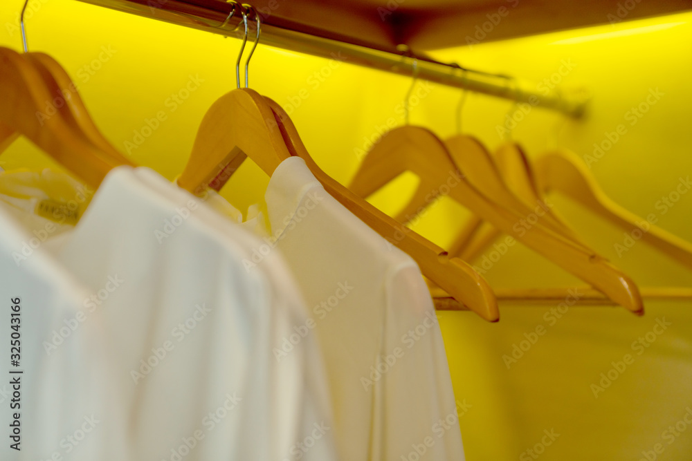 close up hanger closet with shirt uniform hanging home interior design