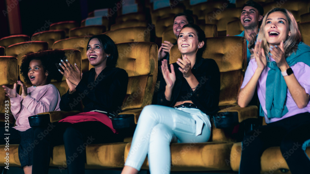 People audience watching movie in the movie theater cinema. Group recreation activity and entertainm