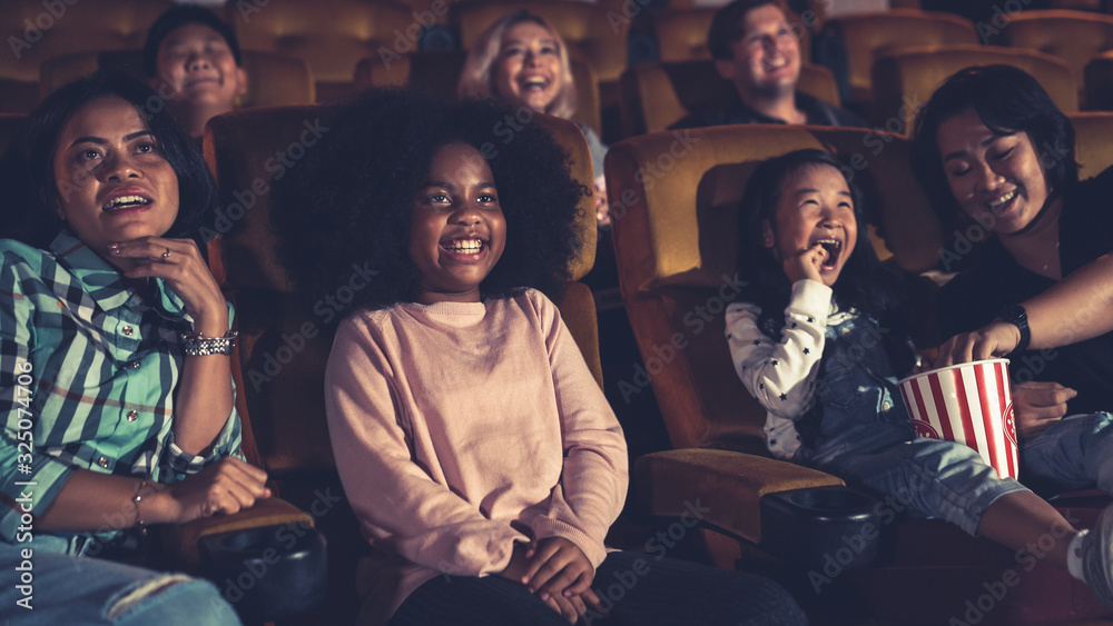 People audience watching movie in the movie theater cinema. Group recreation activity and entertainm