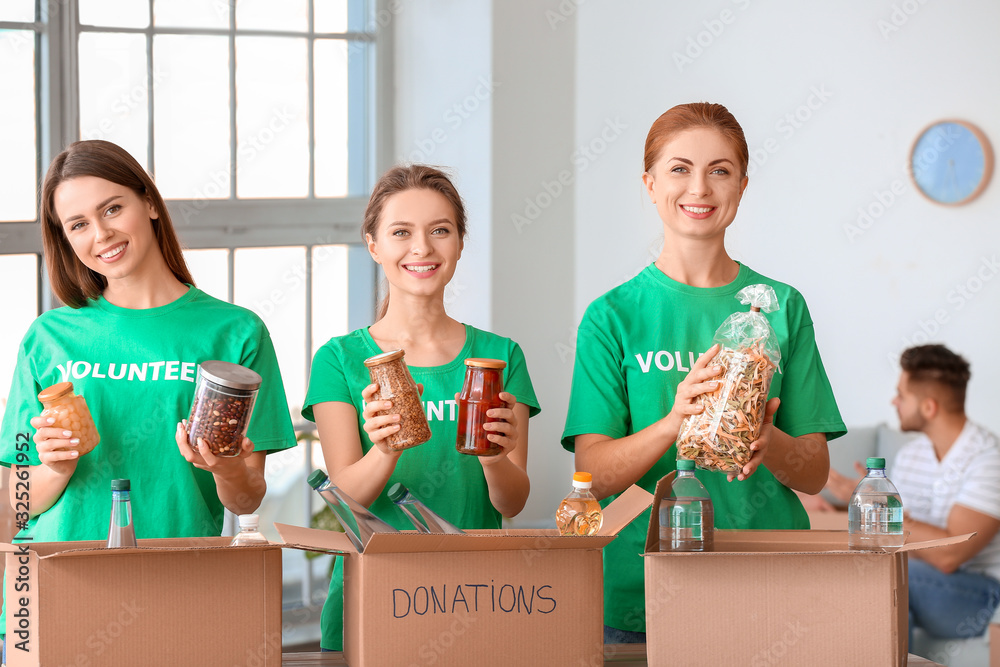 Team of volunteers with products indoors