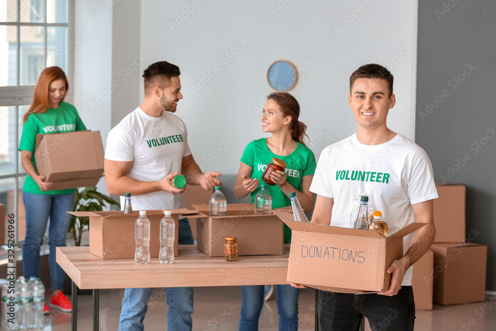 Team of volunteers with products indoors