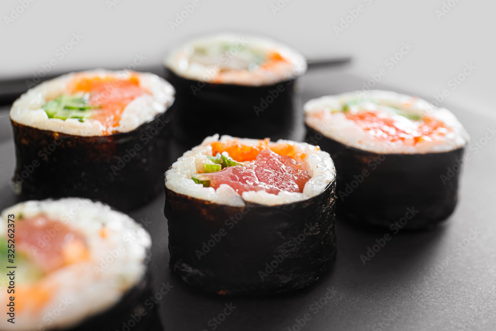 Tasty sushi rolls on table, closeup