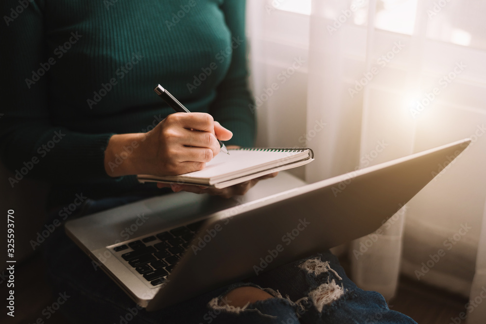 businessman hand working with new modern computer and writing on the notepad strategy diagram as con