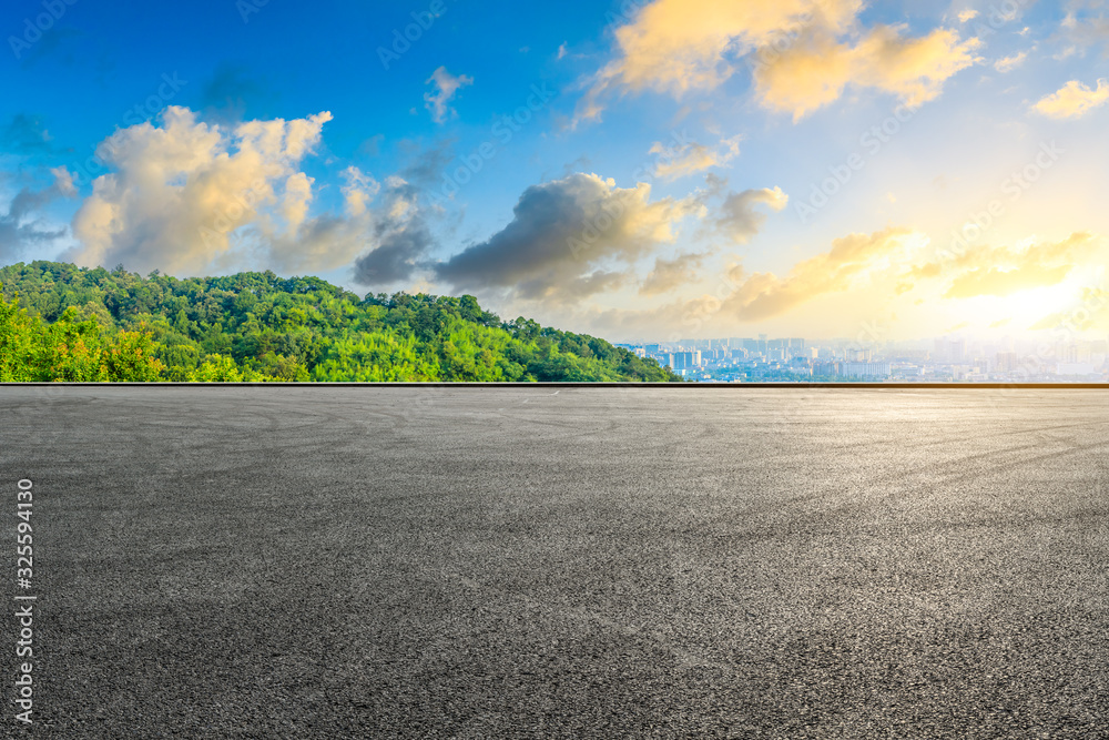 Empty race track and city skyline with green mountain at sunrise in Hangzhou,China.