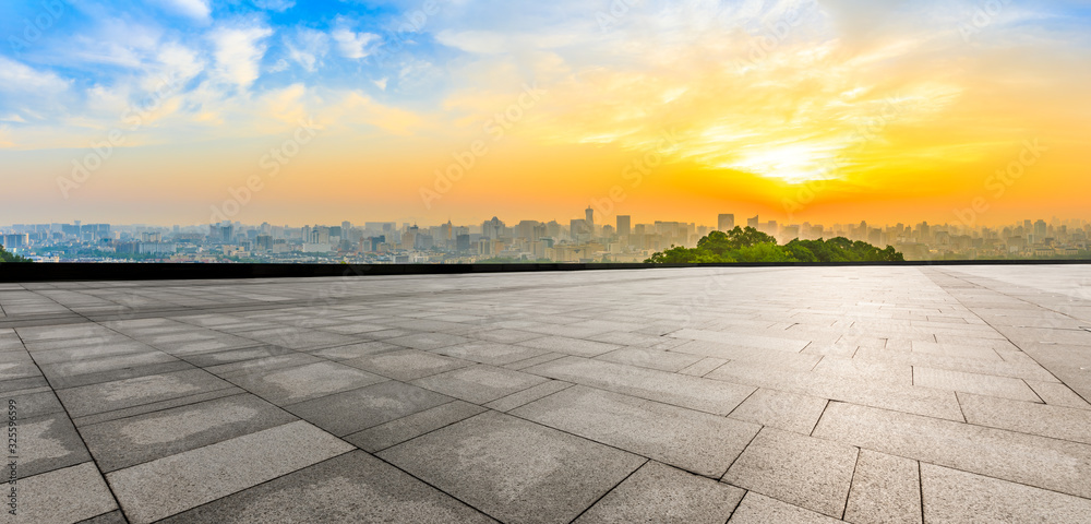 Wide square floor and city skyline at sunrise in Hangzhou,China.