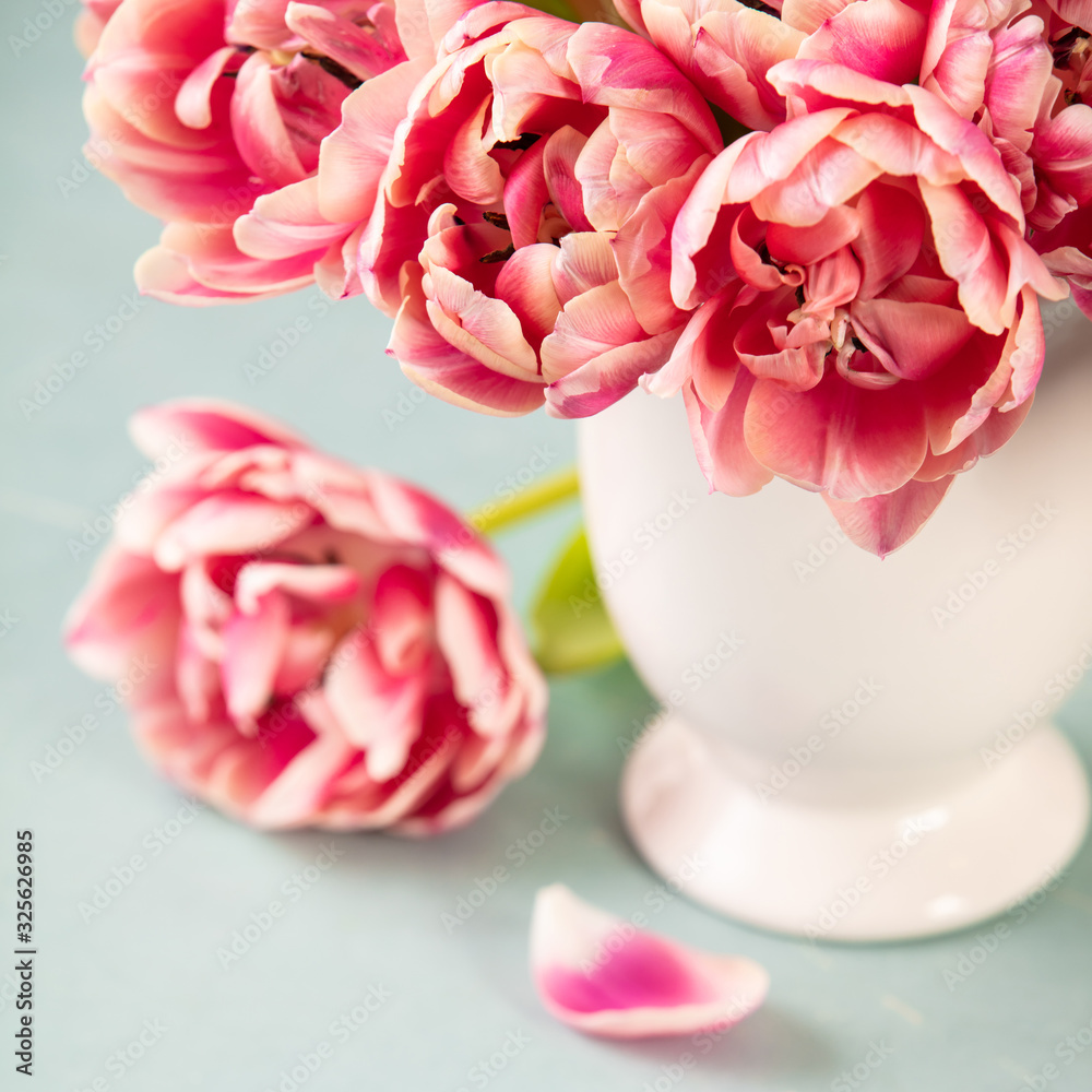 Bouquet of Spring tulips in vase on shabby chic background