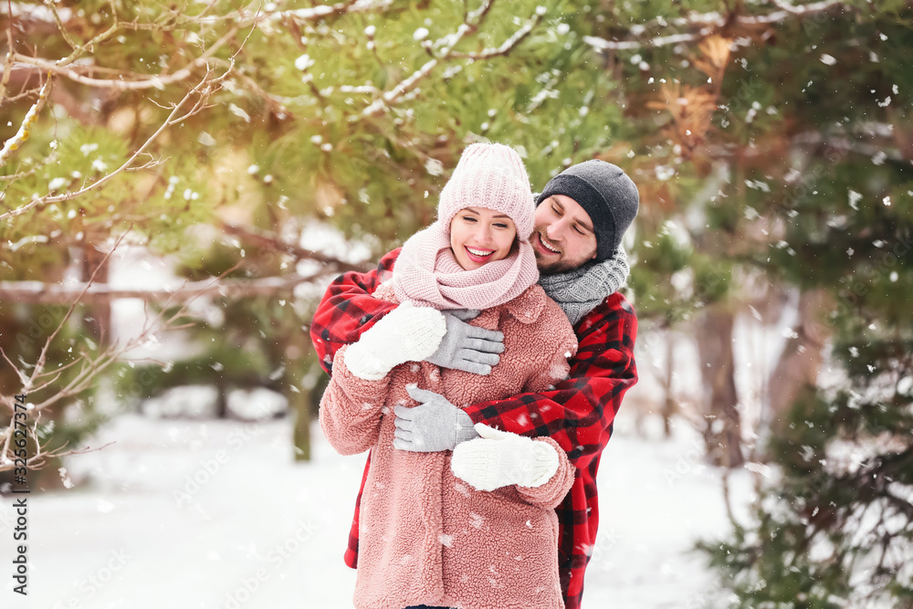 Happy young couple in park on winter day