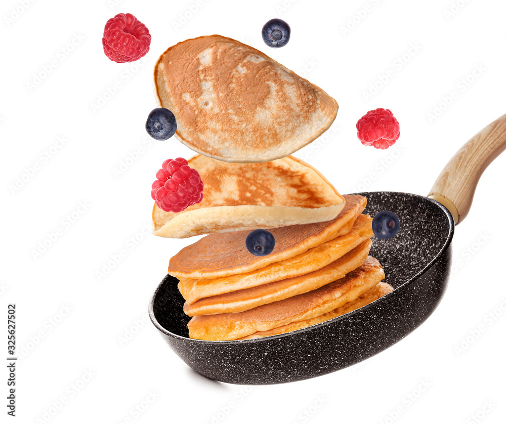 Frying pan with flying pancakes on white background