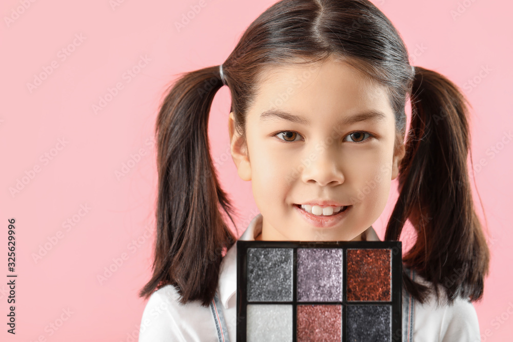 Cute little makeup artist on color background