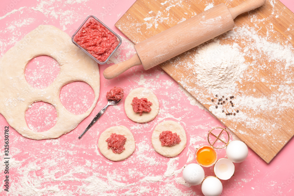 Making of tasty dumplings on color background