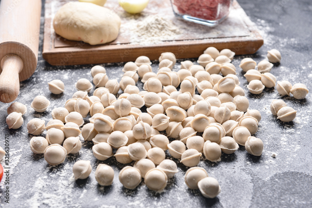 Raw fresh dumplings on dark background