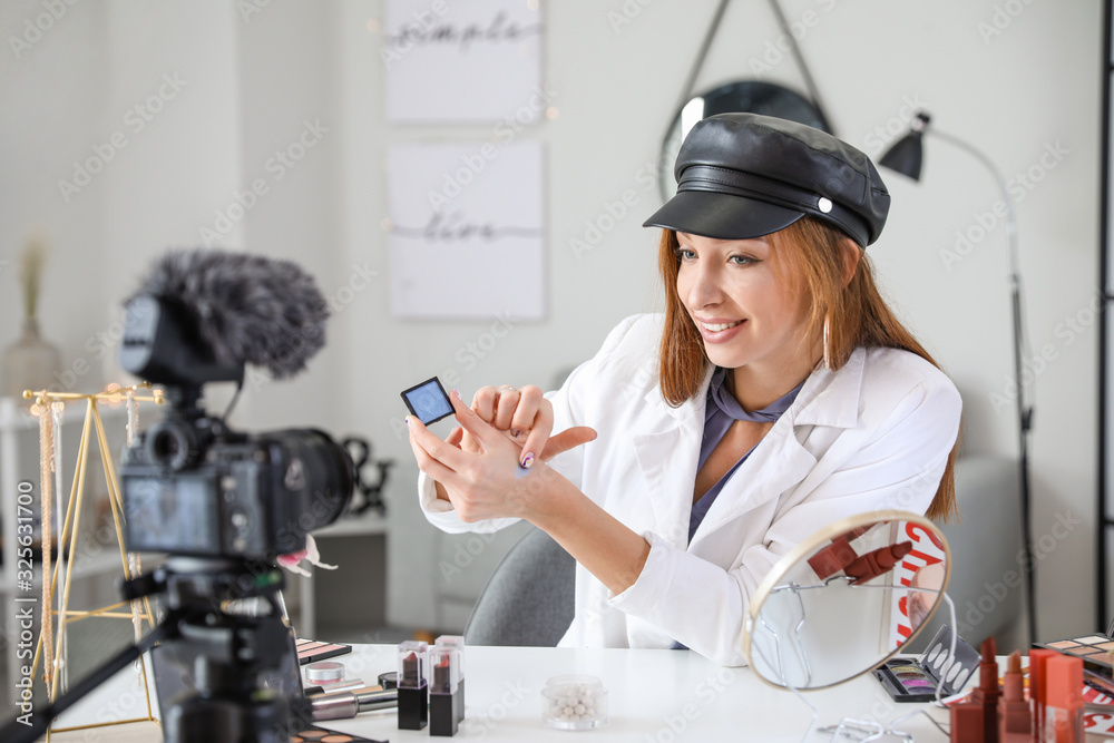 Young beauty blogger recording video at home