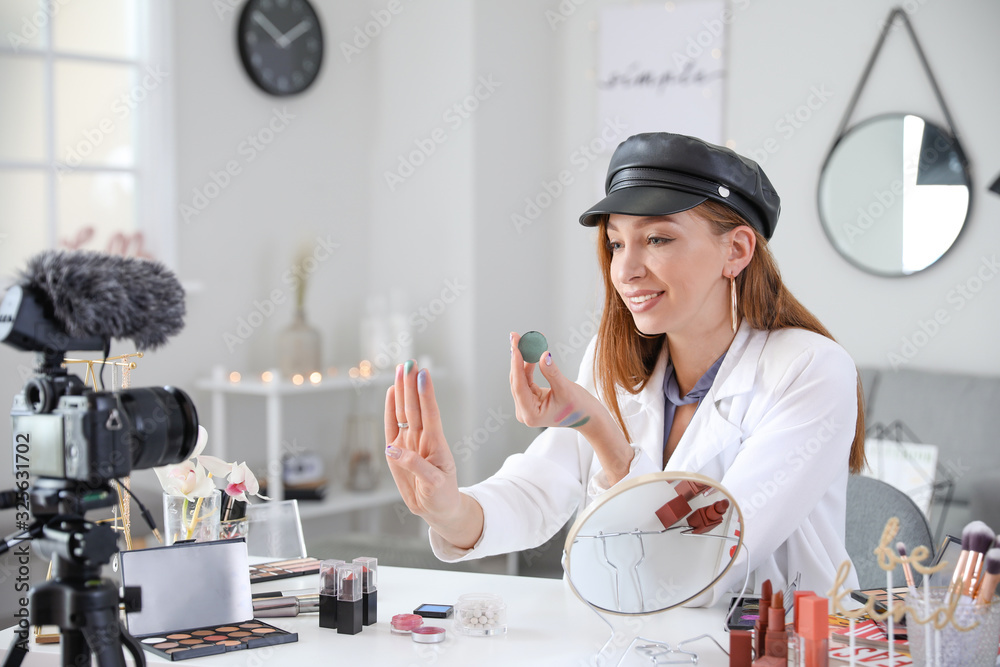 Young beauty blogger recording video at home