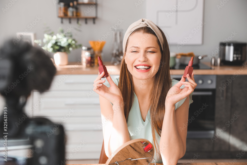 Young beauty blogger recording video at home