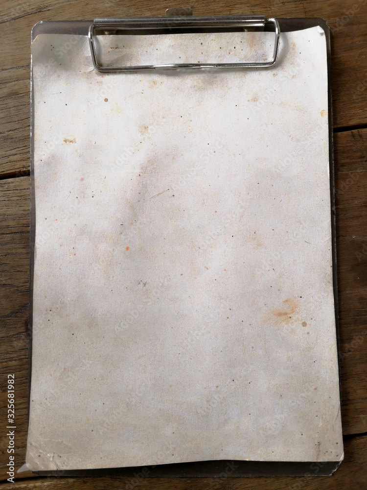 The old blank paper menu on the board, clips placed on a wooden table