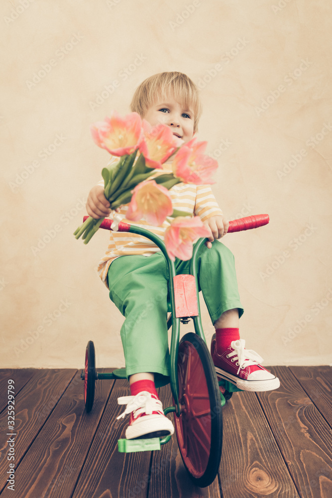 Funny child holding bouquet of flowers