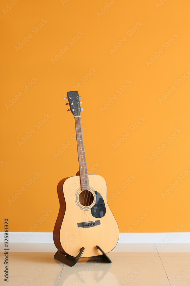 Modern guitar near color wall