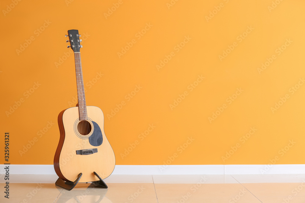 Modern guitar near color wall