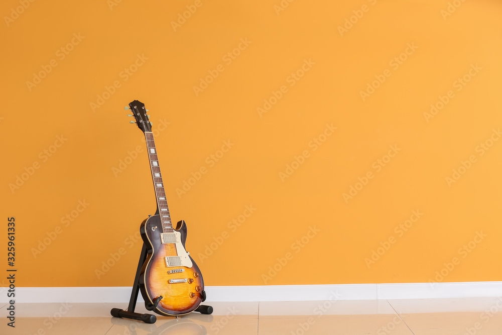 Modern guitar near color wall