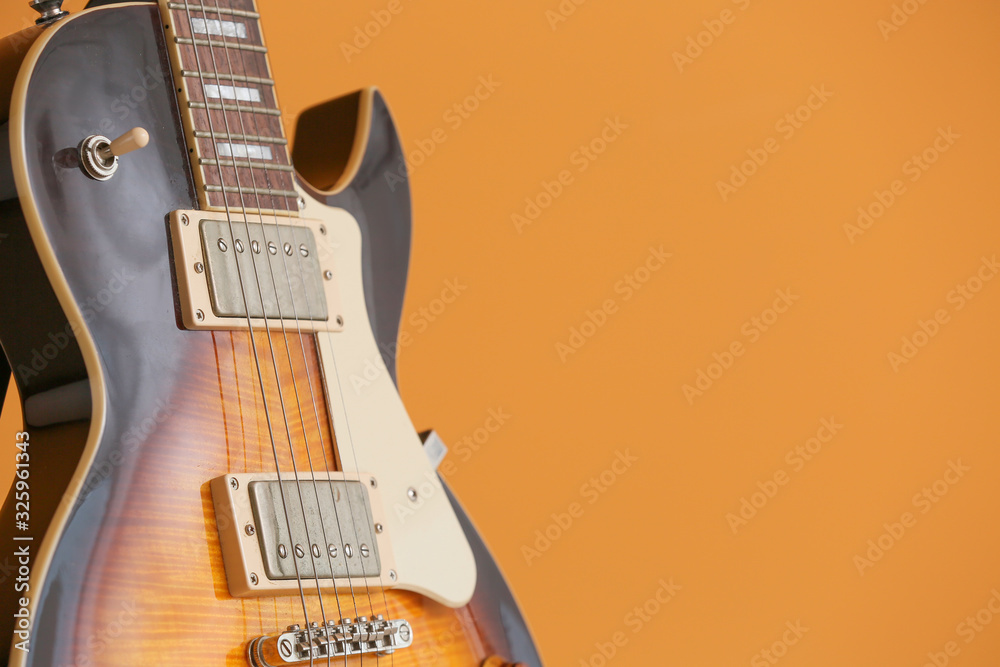 Modern guitar on color background