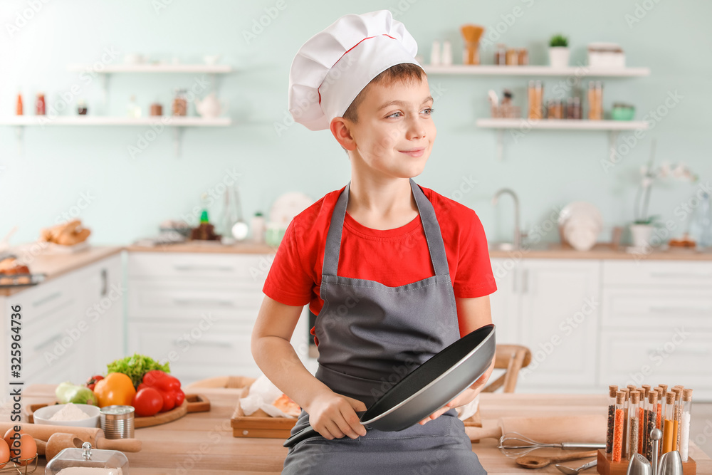 Cute little chef in kitchen