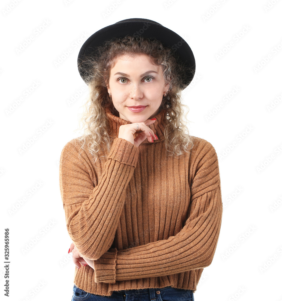 Beautiful young woman in warm sweater on white background