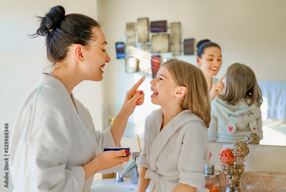 Mother and daughter caring for skin