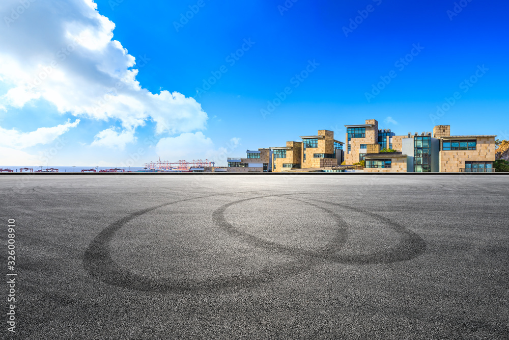 Empty asphalt road and residential building by the sea.