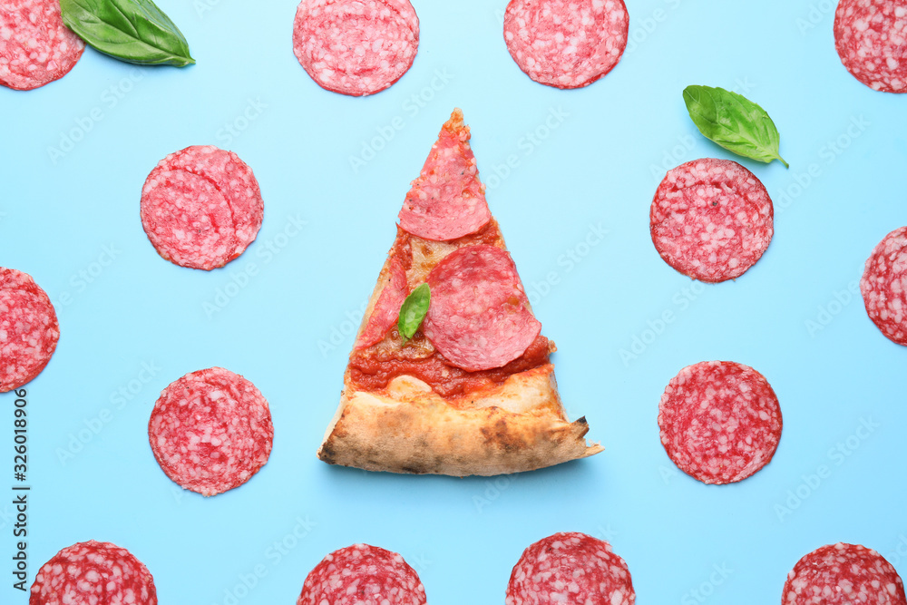 Slice of tasty pizza with sausages on color background