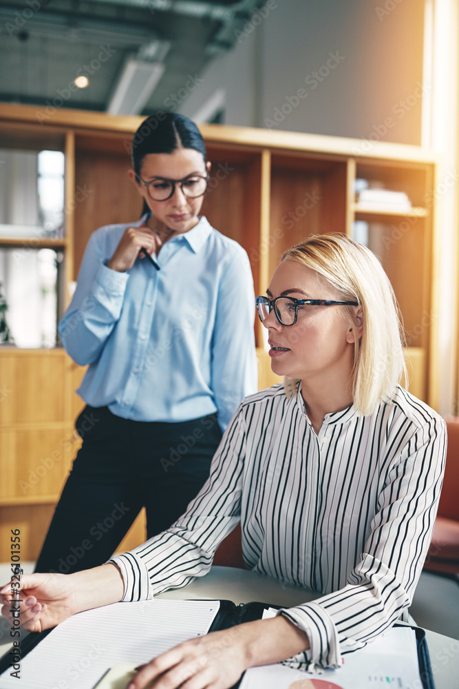 Young businesswoman explaining ideas to coworkers during an offi